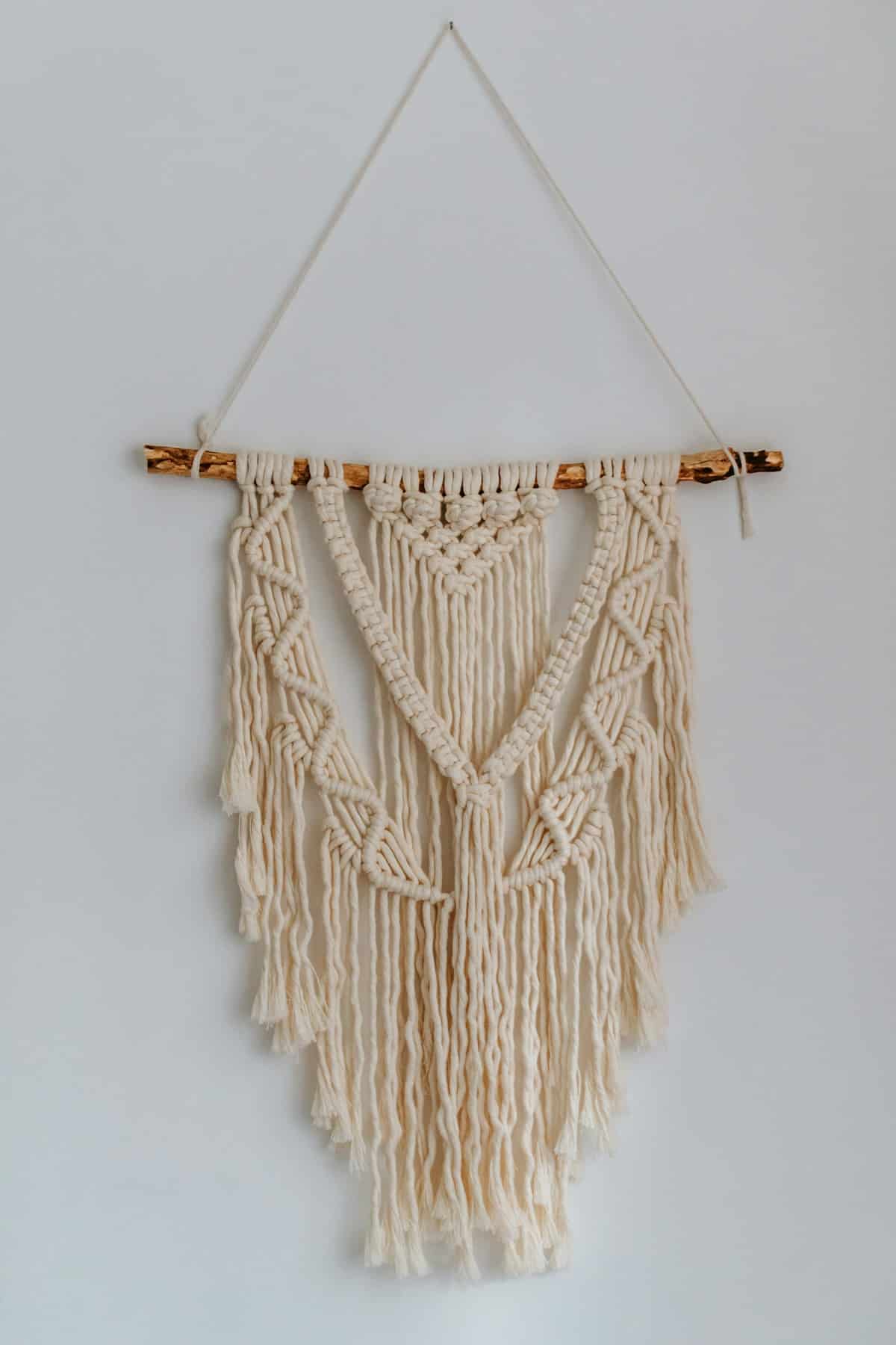 Handmade macrame wall hanging on a white wall